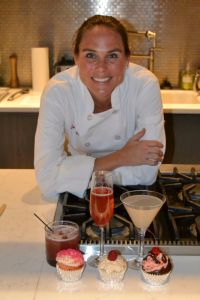 A chef displaying her drinks and cupcakes