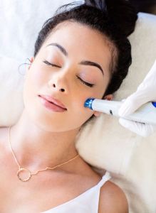 Woman getting facial treatment