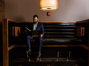 Man sitting at a shoe polish station