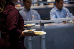 Chief carrying plates of food