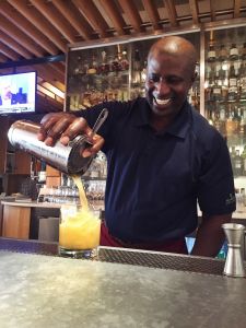 Friendly man pouring a drink