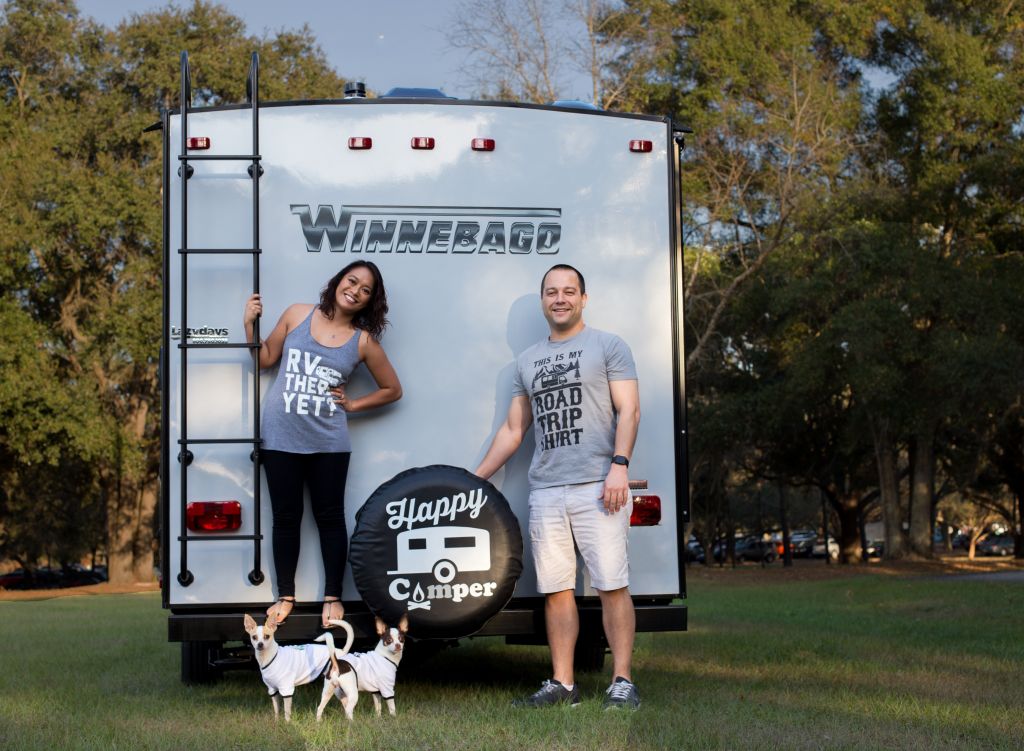 Man and Woman posing with there dogs and van
